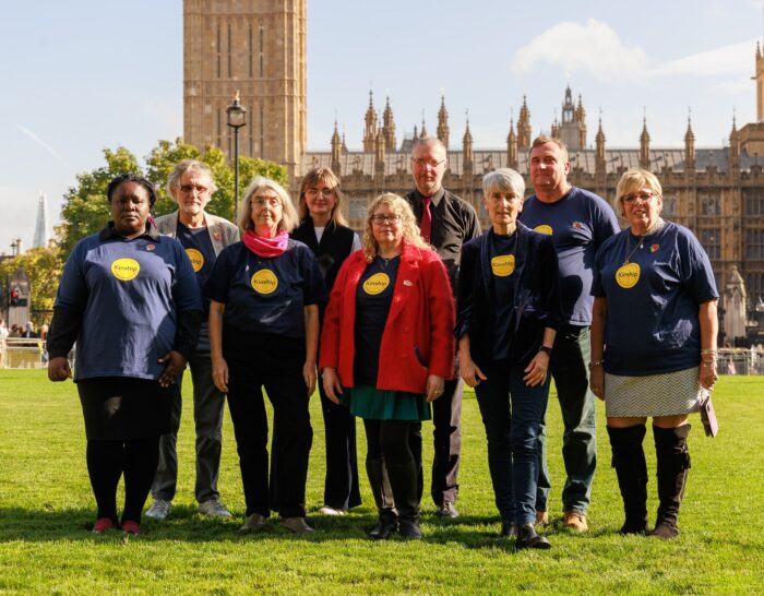 Campaigners outside the House of Parliament wearing Kinship t-shirts
